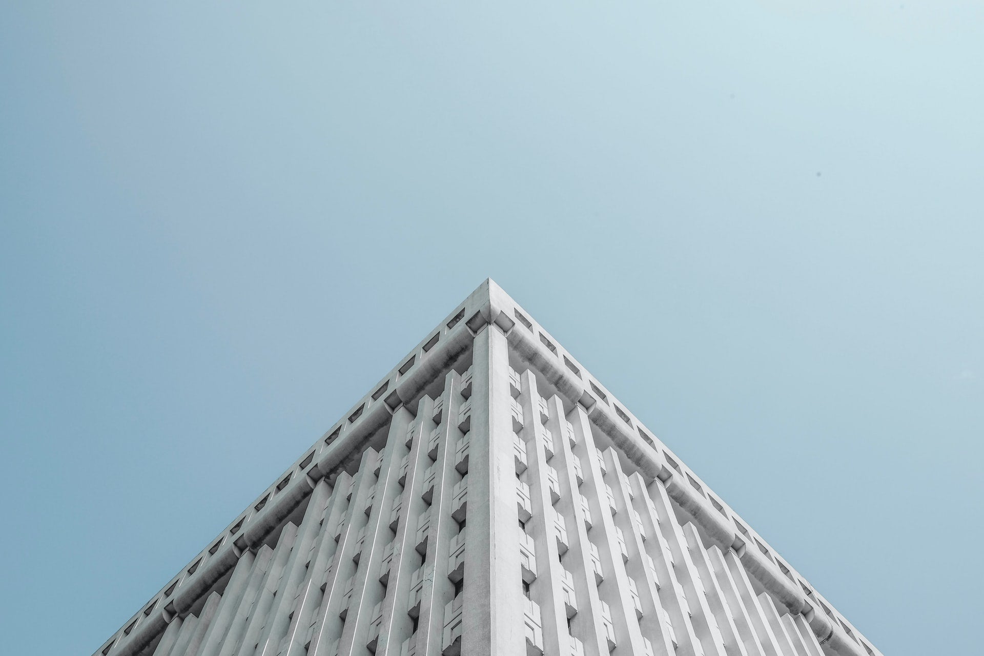 Looking up at a white building