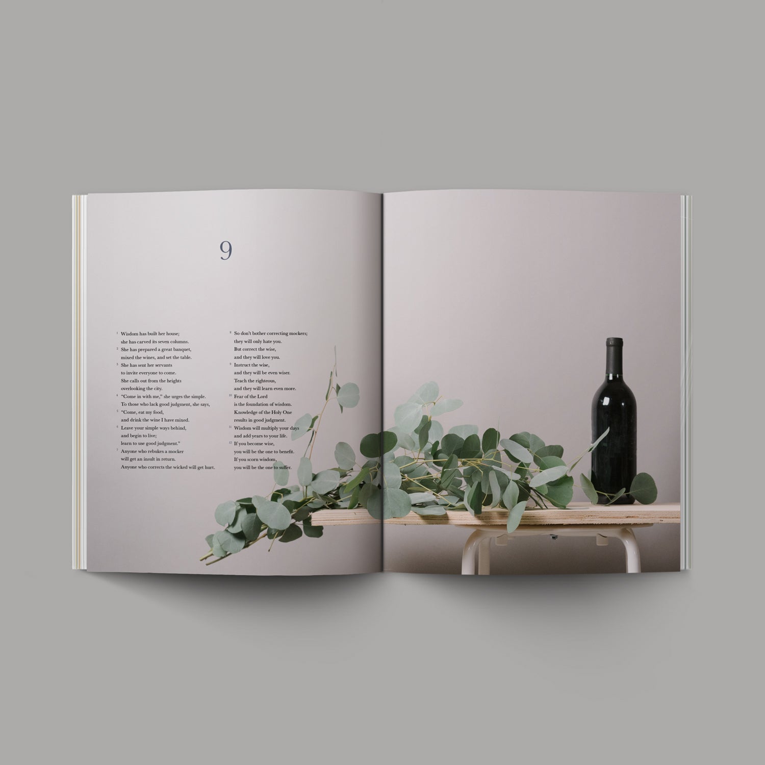 Book of Proverbs Chapter 9 Wooden table with green foliage and wine bottle